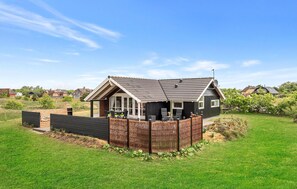A modern house with a sloped roof, a fenced backyard, and a satellite dish. - Amazing home in Skjern with kitchen (Skjern)