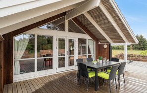 An outdoor deck with a dining table and chairs, a pergola, and a view of a garden. - Amazing home in Skjern with kitchen (Skjern)