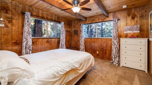 A wooden cabin bedroom with two beds, a ceiling fan, and a dresser. - SNOW, SNOW & MORE SNOW AND SUGAR BEAR IS PLOWED! 12 MIN TO DODGE, 5 MIN TO SLED (Cold Springs)