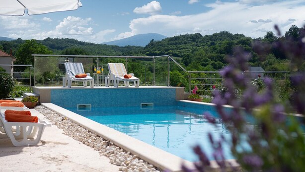 A pool with lounge chairs and a mountain view. - Amazing home in Suhac (Suhac)