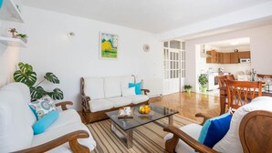 A living room with a sofa, chairs, a coffee table, and a dining area with a table and chairs. - Amazing home in Suhac (Suhac)