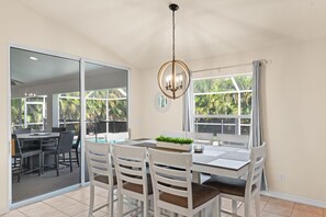 Enjoy meals with family and friends in this spacious dining area, surrounded by lush views and natural light.