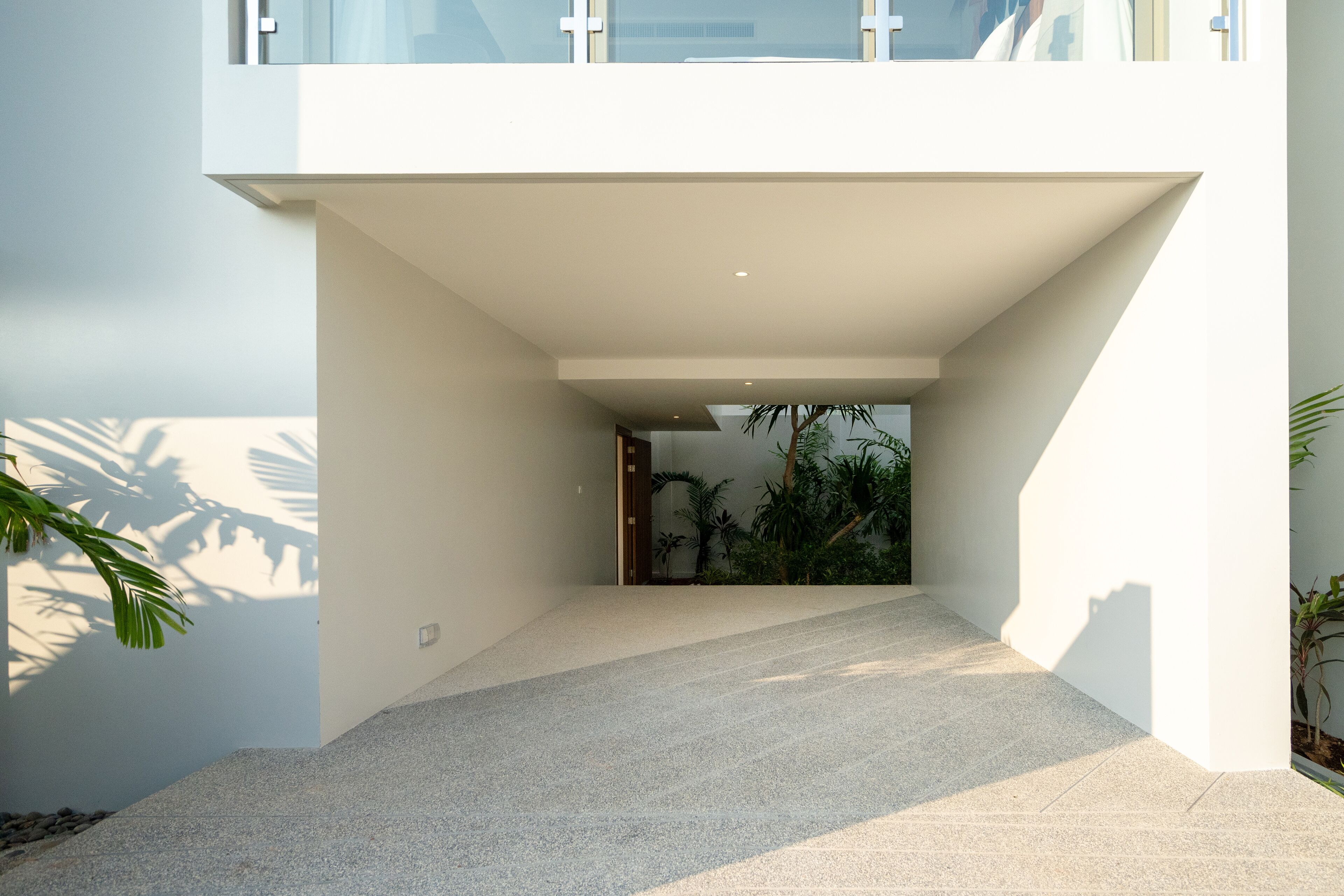 A modern building with a clean, white exterior and a sloped roof.