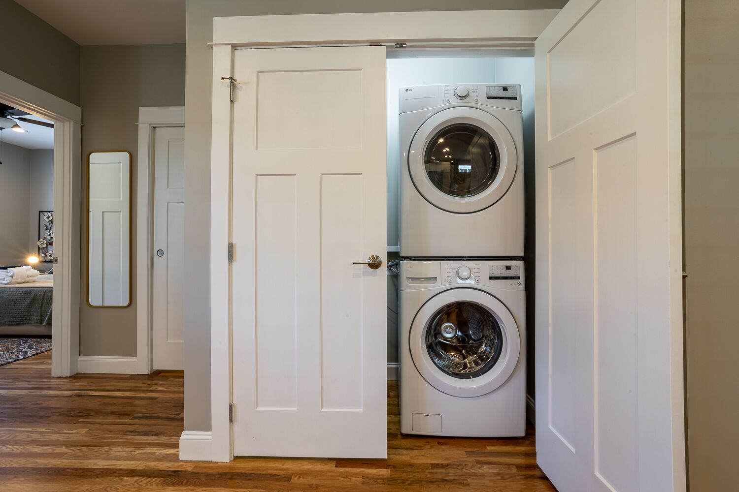 A laundry room with two stacked front-loading washing machines.