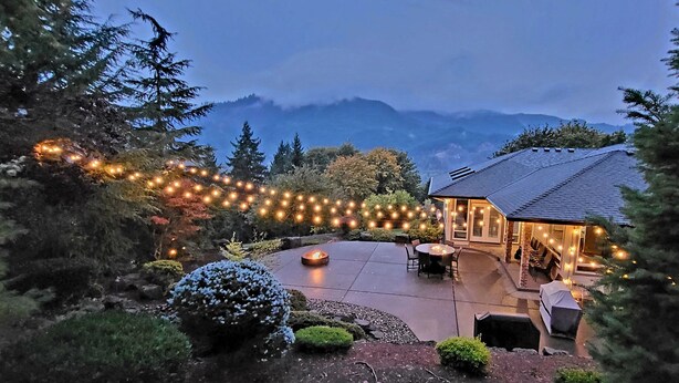A house with a patio, outdoor seating, and string lights. - New Listing - Breathtaking vacation/work remotely in wine country! (Forest Grove)