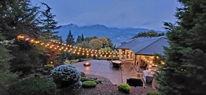 A house with a patio, outdoor seating, and string lights. - New Listing - Breathtaking vacation/work remotely in wine country! (Forest Grove)