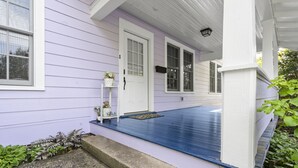A house with a porch, a white door, and a window. - Walk to Downtown Brevard  Pets Welcome Large Fenced Yard Porches Biking Hiking (Brevard)