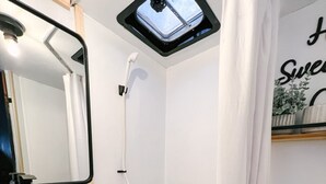 A bathroom with a shower, toilet, and sink. - Cute Renovated RV Near Zion & St. George (Leeds)