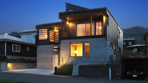 A modern two-story house with a balcony, large windows, and a garage. - Orchid Furano (Furano)