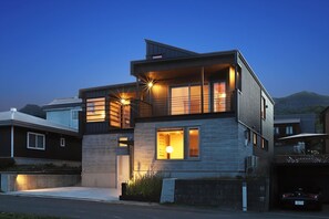 A modern two-story house with a balcony, large windows, and a garage. - Orchid Furano (Furano)