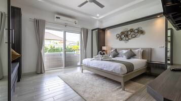 A modern bedroom with a large bed, a ceiling fan, a balcony with curtains, and a wall-mounted air conditioner.