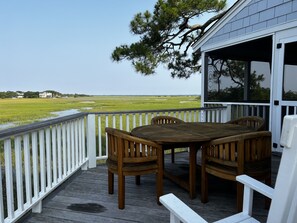 A wooden deck with a table and chairs, overlooking a marshy landscape. - Beautiful Marsh & Golf view. Walking distance to the beach & Conference Center. (Isle of Palms)