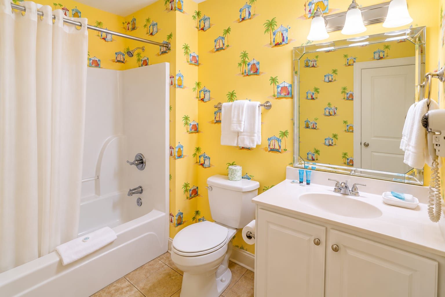 A bathroom with a bathtub, toilet, and sink.