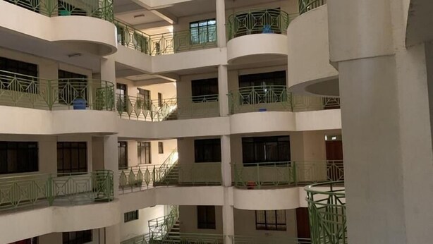 A multi-level atrium with balconies, a central open space, and a tiled roof. - Immaculate 2-bed Apartment, Langata, Nairobi (Nairobi)