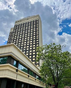 A modern building with a grid-like facade and a flat roof.
