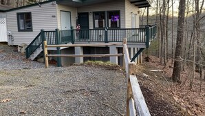 A cabin with a front porch, a deck, and a satellite dish. - Mountain Cabin in the woods-Tranquil Setting-2 bed 2 bath-Private-Deck-Views (Brasstown)
