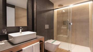 Habitación Deluxe con 2 camas individuales | Baño | Regadera, regadera tipo lluvia, amenidades de baño gratuitas 