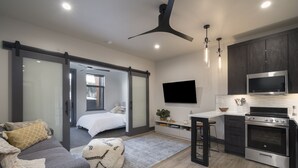 Un appartement moderne comprenant un salon, une cuisine et une chambre.