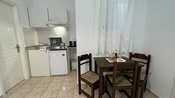 Quadruple Room | Living area | 28-inch flat-screen TV with cable channels, TV