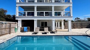 A two-story house with a swimming pool in front. - Walk to tradin post!North cape, private pool, awesome patio & steps to beach! (Port Saint Joe)