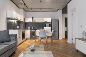 Enjoy a compact yet functional stay with a kitchenette, dining area, and living space.