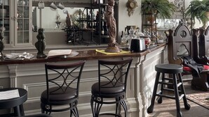A spacious kitchen with a central island, bar stools, and a chandelier. - Beautiful, artistic, unique and beyond large and spacious apartment (Little Falls)