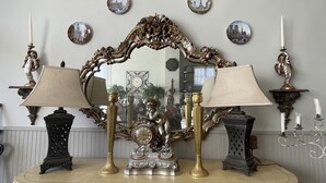 A vintage-style dresser with ornate carvings and a large mirror above it. - Beautiful, artistic, unique and beyond large and spacious apartment (Little Falls)