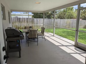 Enjoy al fresco dining on the patio with a barbecue grill and comfortable seating for four.