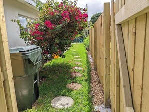 Stroll through a serene garden, surrounded by lush plants and vibrant blooms.