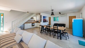 A modern apartment with a kitchen, dining area, and living room. - Villa with exceptional views (Labin)