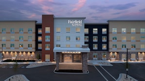 A multi-story hotel with a central entrance, multiple floors, and a parking lot. - Fairfield Inn & Suites by Marriott Boise West (Boise)