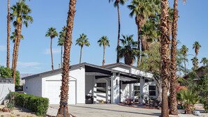 A single-story house with a garage, surrounded by palm trees and desert landscaping. - LOCATION LOCATION LOCATION Gorgeous Villa Mystique (Palm Springs)