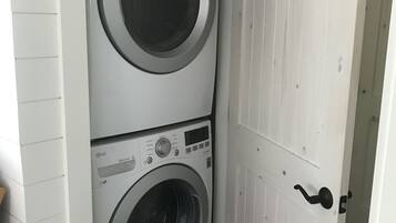 Un lavadero con dos lavadoras apiladas.