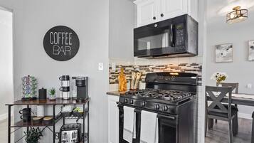 Microwave, dishwasher, coffee/tea maker, cookware/dishes/utensils