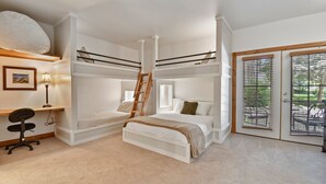 A bunk bed room with a desk, ladder, and large windows. - Family Getaway ,Pool, Tubing, Skiing, & Ice Castles Villa 1002 (Midway)