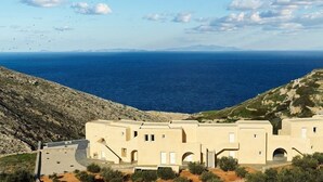 Un edificio costero con techo plano, varias ventanas y vista al mar.