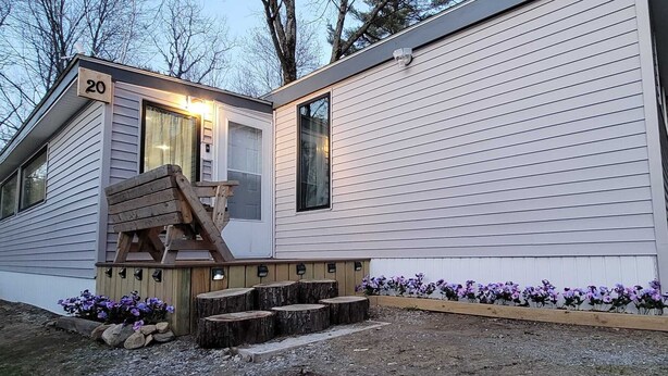 A single-story mobile home with a number '20' displayed on the front.