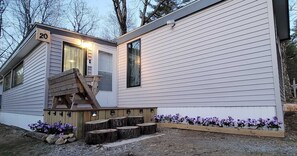 A single-story mobile home with a number '20' displayed on the front.