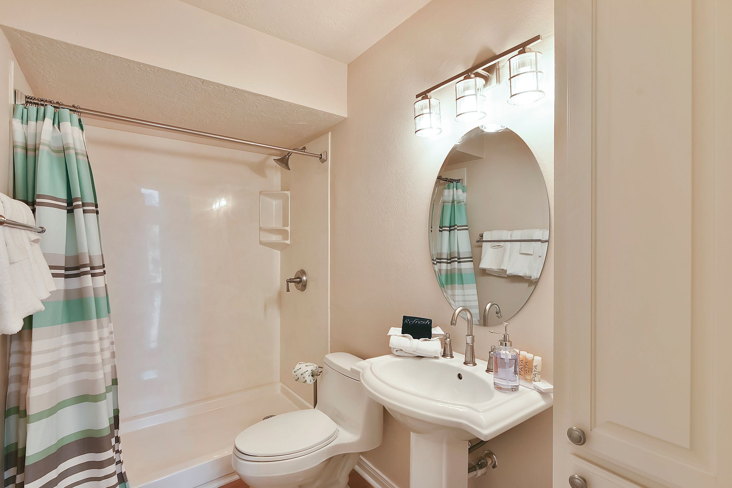A bathroom with a bathtub, toilet, and sink.