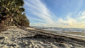 A beach with clear skies, sandy terrain, and sparse vegetation. - Sarasota-Indian Beach Zen Home (private-pet friendly)  (Sarasota)