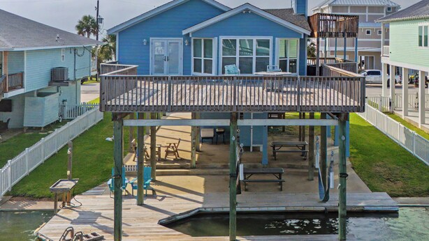A waterfront property with a dock, a covered outdoor seating area, and a pool. - 1 Mi to Sea Isle Beach: Canal-Front Gem w/ Dock! (Galveston)