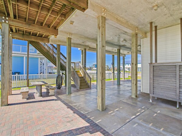 Stroll through this charming outdoor space, featuring a central staircase and a metal bench near the entrance.