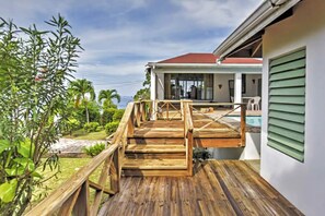 Guests can enjoy a deck with a staircase leading to a covered outdoor area.