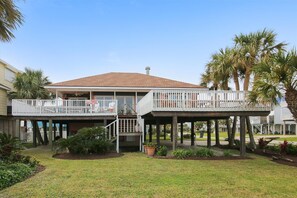 A two-story house with a balcony and a covered porch.