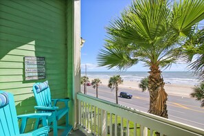 A green porch with a view of the beach and ocean. - Turtle Romance by Ryson Vacation Rentals (Galveston)