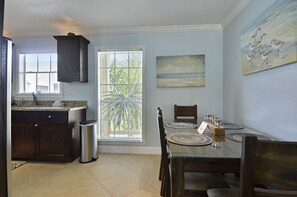 Enjoy meals in the kitchen with a dining area for four, featuring a wooden table and chairs.