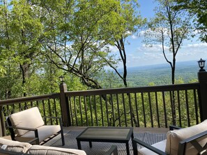 Relax on the deck with a view of the lush landscape.