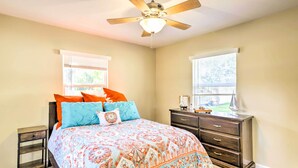 A bedroom with a bed, a dresser, a nightstand, and a ceiling fan. - < 1 Mi to Lake Weir: Quiet Summerfield Getaway (Summerfield)