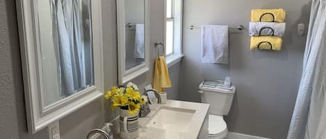 Combined shower/bathtub, hair dryer, towels, soap