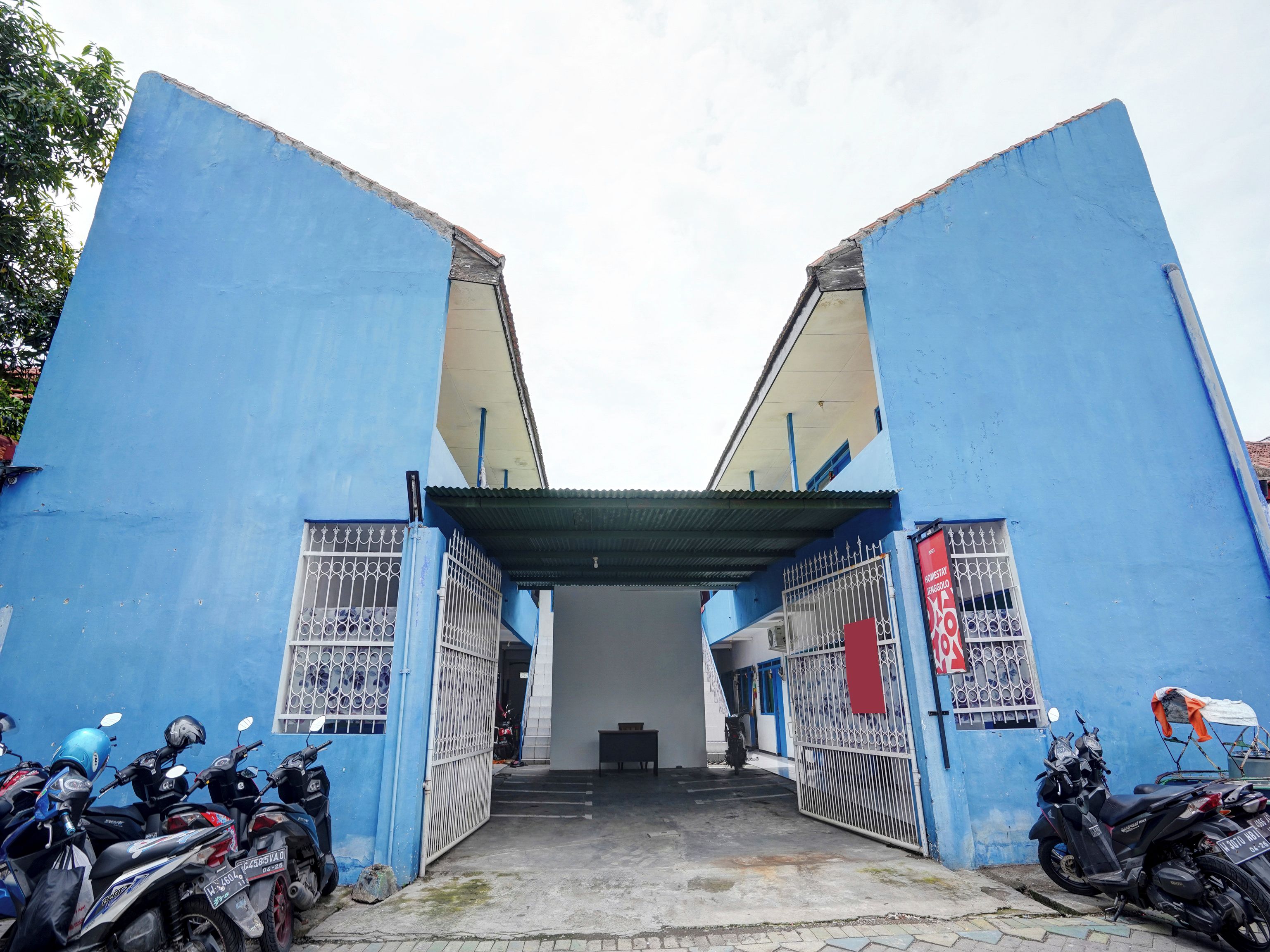 A building entrance with blue walls and metal gates.